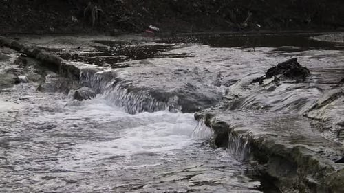 Flowing clear river water stream. Rapid river with water fall