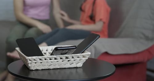 Smartphones Placed in Basket for Digital Detox