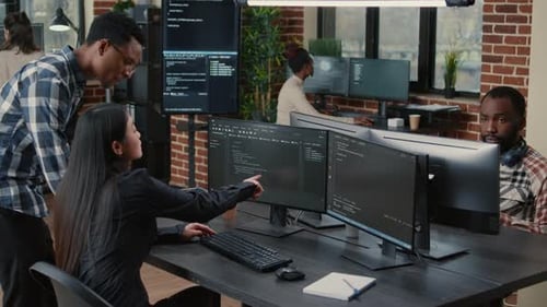 Mixed Team of Programmers Analyzing Source Code Pointing at Screens Comparing Algorithm