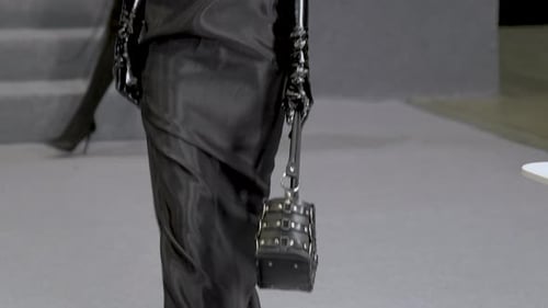 Trendy Blonde Female Model in Satin Dress with Latex Gloves Walking Down Runway