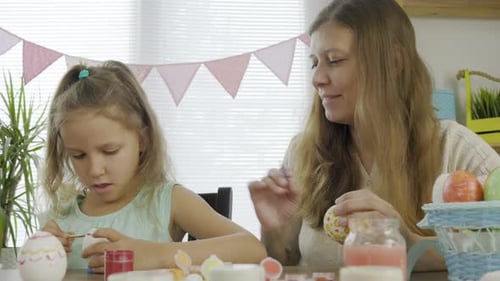 Mother Woman With Daughter Girl Coloring Eggs For The Bright Holiday Easter