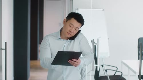 Professional Adult Talking on Phone in Office