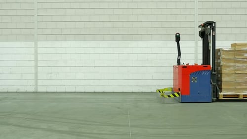 Forklift Carrying Pallet of Boxes in Warehouse