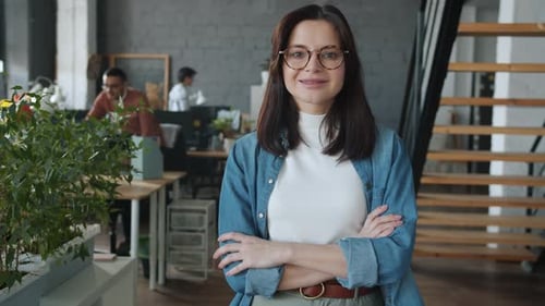 Slow Motion of Attractive Girl Employee Standing in Office Smiling Looking at Camera