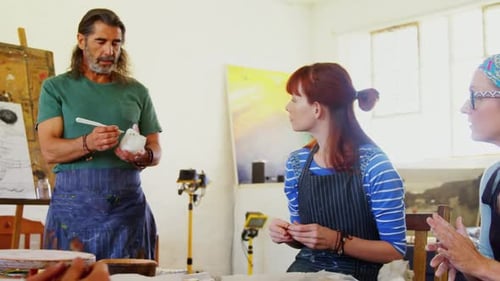 Adults in Pottery Class in Sunny Art Studio