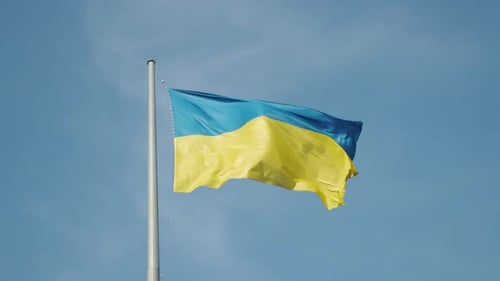 Ukrainian Flag Waving Against Blue Sky