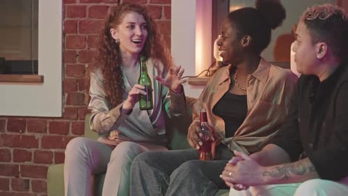 Girlfriends Talking on Sofa at Home Party