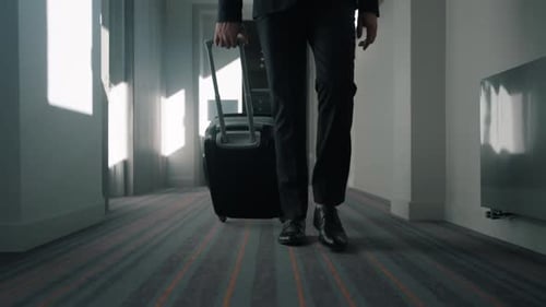 Business Man Legs with Travel Suitcase Walking at Hotel Corridor