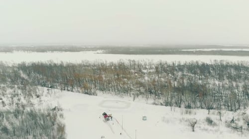 Ski Track on Snowy Hill at Winter Wood and River Upper View