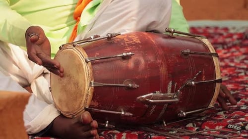 Drummer Playing Traditional Indian Instrument in the Street