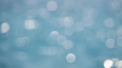 Shimmering Water Background with Bright Bokeh