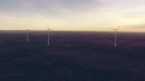 Large Wind Turbines with Blades in Field Aerial View at Dusk