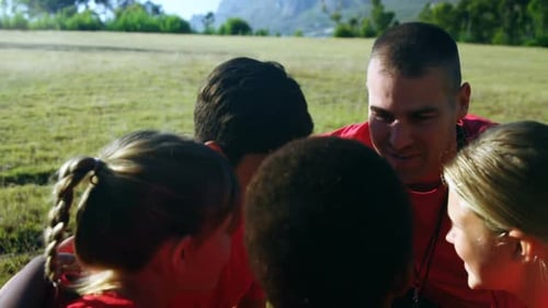 Male trainer interacting with kids in the boot camp 4k