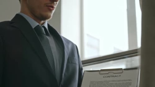 Businessman Explaining Contract in Bright Modern Office