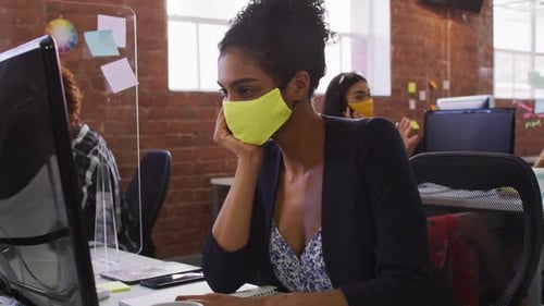 Employees Wearing Face Masks Working in Modern Office