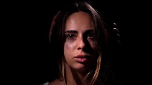 Distressed Woman's Face Covered by an Unseen Hand