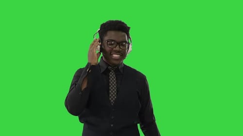 Smiling Man Talking with Headphones on Green Screen