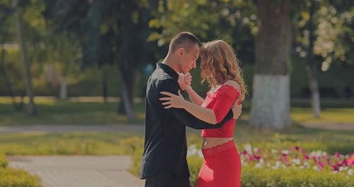 Couple Dancing in the Park on a Sunny Day