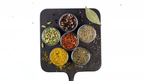 Spices Rotating on a Black Board