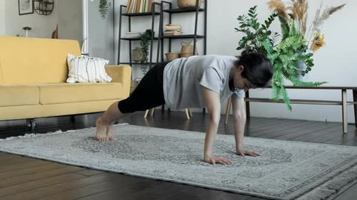 Woman Exercising Plank in Bright Living Room