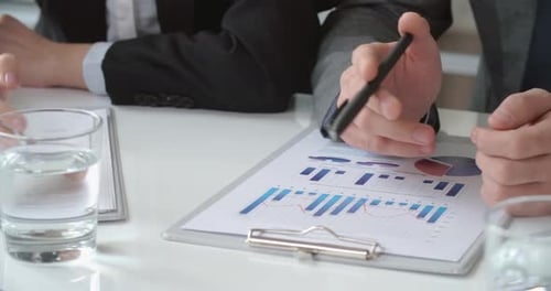 Business Colleagues Discussing Financial Data at Meeting