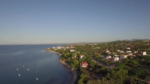 - Coastal Town Scene with Blue Sea. Aerial View of Trikorfo Beach, Greece