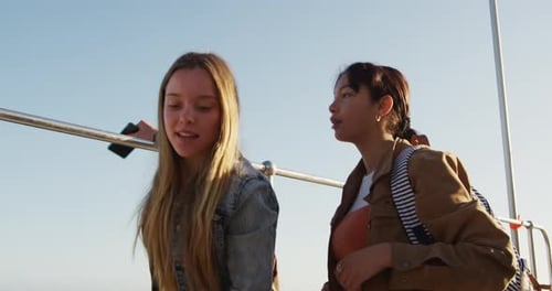 Side view of a Caucasian and a mixed race girl hanging out together