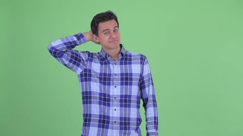 Man Gesturing and Scratching Head in Confusion