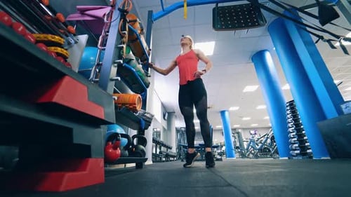 Girl doing exercise in sports gym.