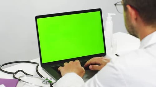 Close-up of Doctor Using Chromakey Laptop While Work