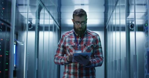 Man uses Tablet in Data Center Server Room
