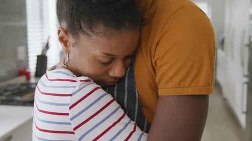 Couple Embracing Affectionately in a Kitchen