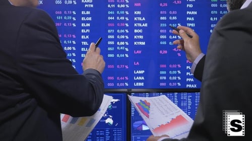 Businessmen Analyzing Financial Market Data in an Office