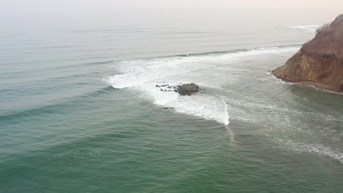 Powerful Waves Forming Breaking on the Shore and Splashing with White Foam