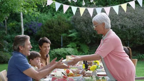 Family eating outside together in summer