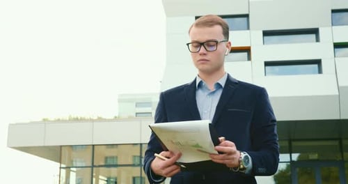 The Businessman Is Looking Through the Documents and Making Edits