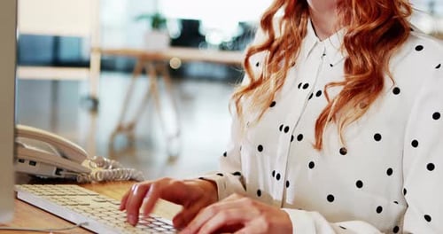 Woman Typing at Computer in Modern Office