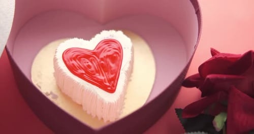 Top View of Heart Shape Cake Gift Box and Rose Flower on Red Background