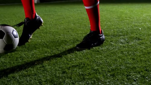Low section of soccer player and ball on field 4k