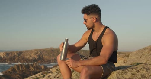 Tranquil man enjoying seascape in summer at sunset