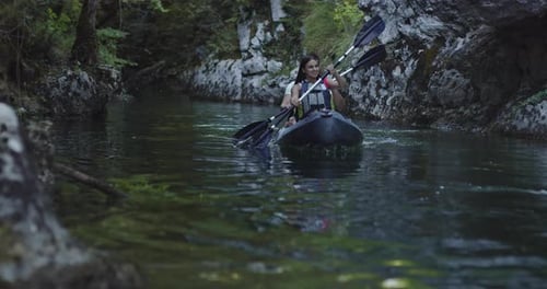 Couple Kayaking on River Adventure in Nature