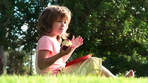 Boy Eating Fresh Apple Outdoor