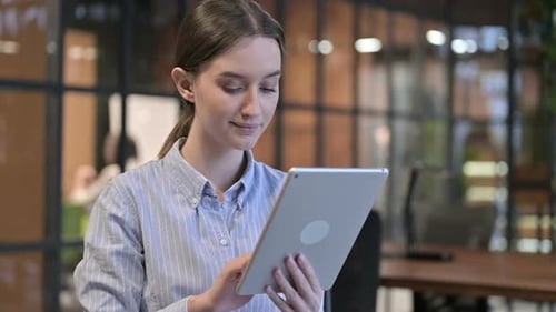 Young Woman Using Tablet Device in Office