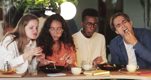 Crop View of Young Hungry Friends Eating Tasty Food in Cafe During Meeting. Millennial Multi Ethnic