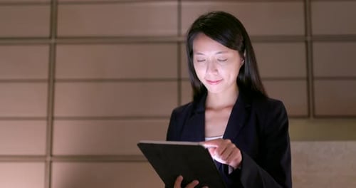 Woman in Business Suit Using a Tablet