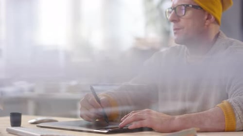 Man Working on Graphic Tablet in Modern Office