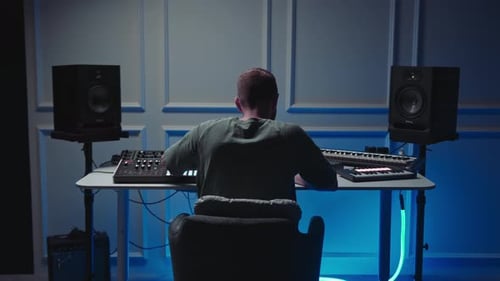Music production studio. Producer. Man working in the recording studio with computer and mixer