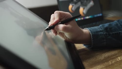 Hand Using Stylus and Drawing Tablet for Design