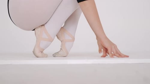 Close Up of a Ballet Dancer's Feet in White Studio