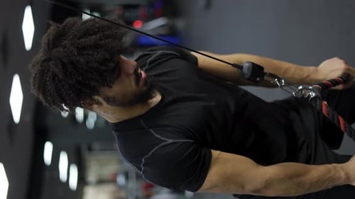 Young Man Exercising on Multistation at Gym Slow Motion
